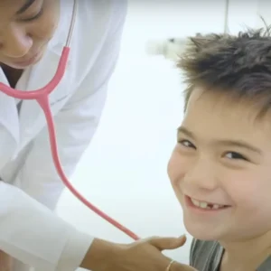 stem cell therapy Young boy smiling as doctor listens to his heart at Stem Cell Institute Panama