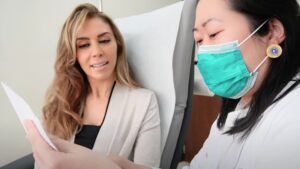 nurse showing a stem cell patient her stem cell therapy protocol