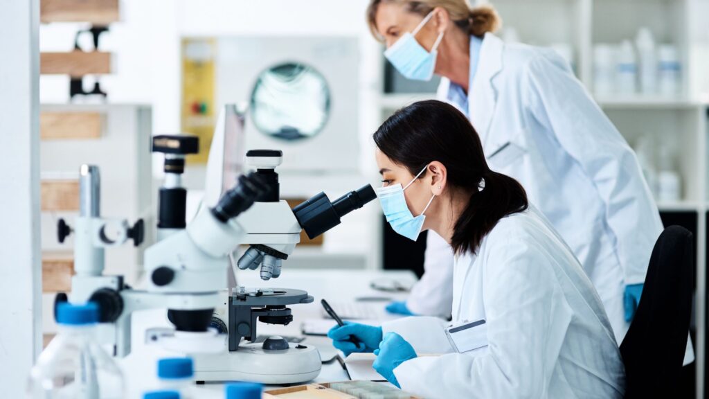 stem cell therapy for knees young scientist working in a lab with her colleague in the background